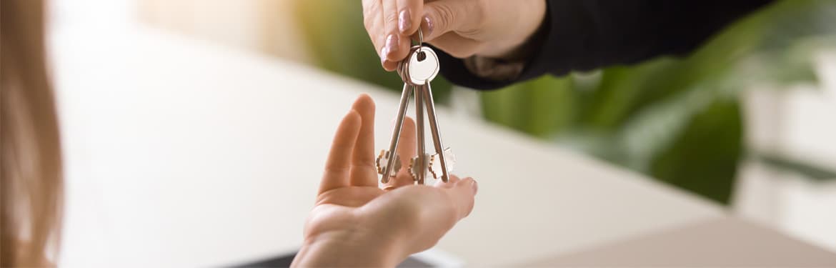 Real estate agent handing over house keys